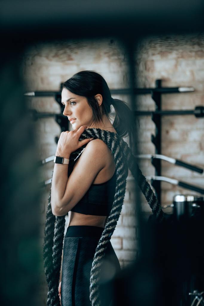 Fit woman carrying rope 
