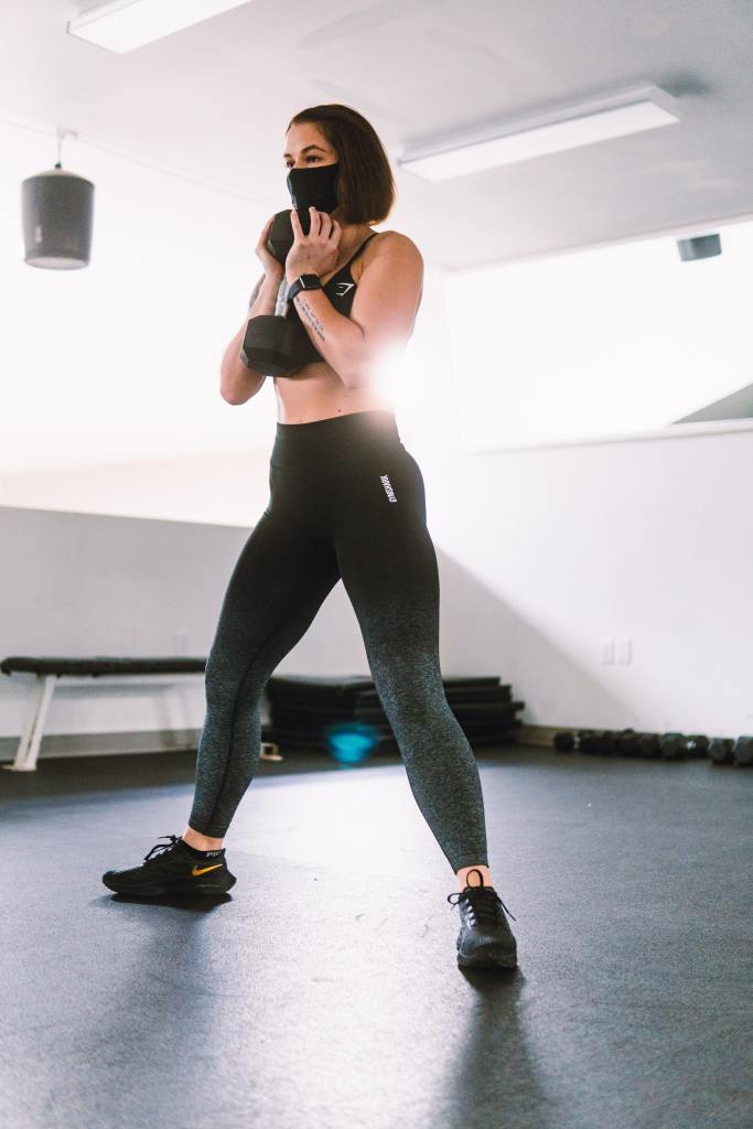 Masked woman about to squat