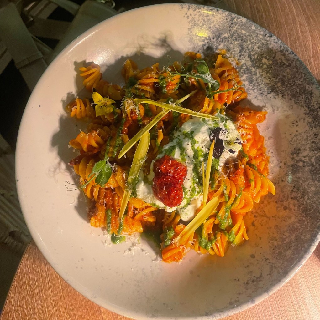 Tomato pasta with cheese on top 
