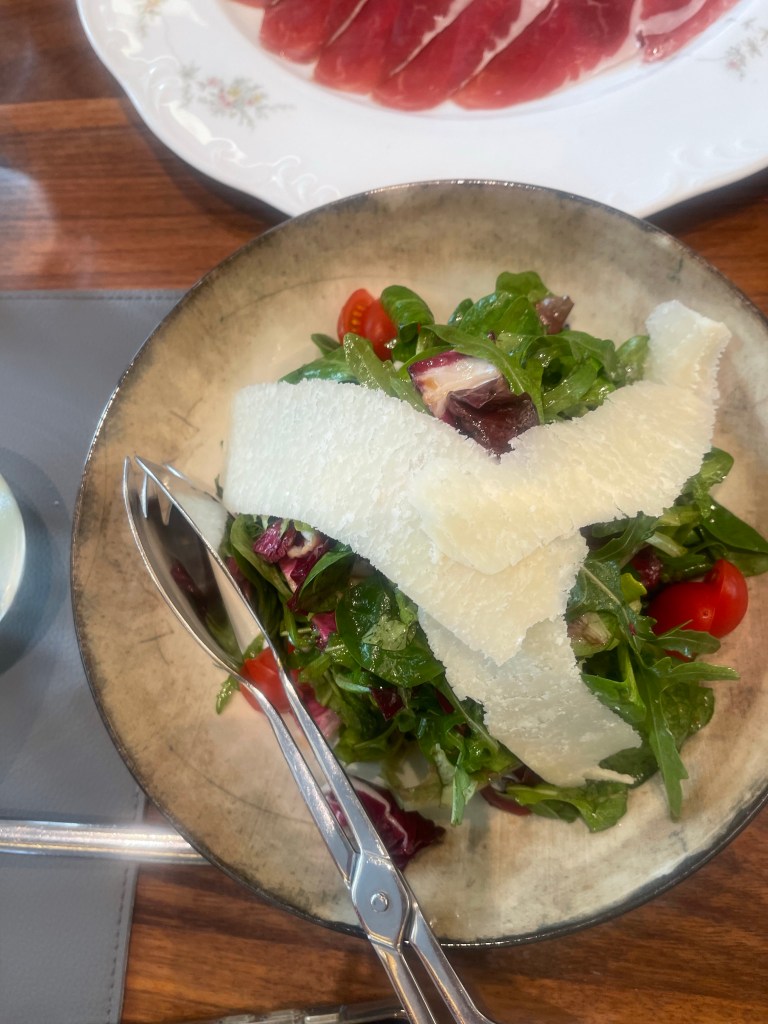 Salad with Parmesan cheese on top 
