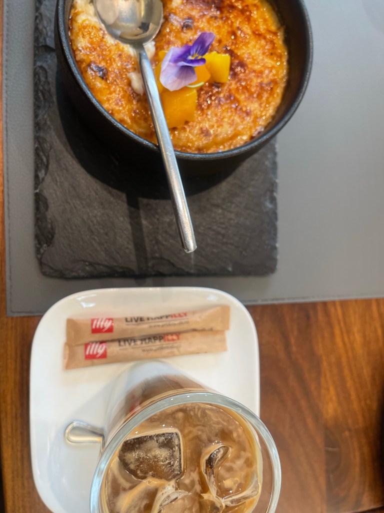 Rice pudding with cafe latte next to it 