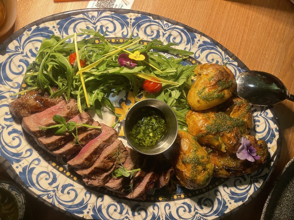 Sliced steak, potatoes and salad 