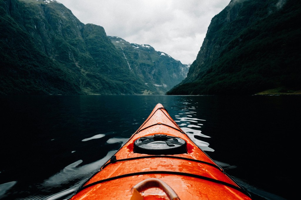 Red canoe in lake 
