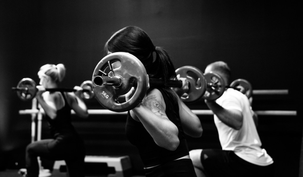Woman mid lunge in training class 
